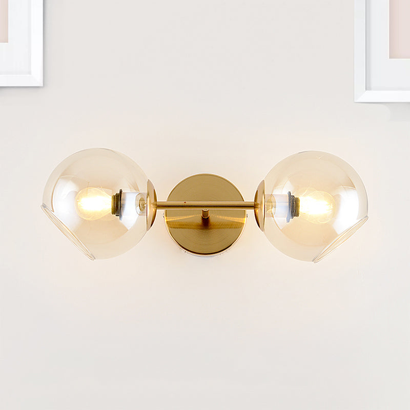 Modernist 2 Lights Wall Lamp with Clear Glass Shade Gold Spherical Wall Mount Light Fixture Gold Clearhalo 'Cast Iron' 'Glass' 'Industrial' 'Modern wall lights' 'Modern' 'Tiffany' 'Traditional wall lights' 'Wall Lamps & Sconces' 'Wall Lights' Lighting' 242547