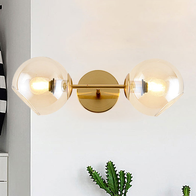 Modernist 2 Lights Wall Lamp with Clear Glass Shade Gold Spherical Wall Mount Light Fixture Clearhalo 'Cast Iron' 'Glass' 'Industrial' 'Modern wall lights' 'Modern' 'Tiffany' 'Traditional wall lights' 'Wall Lamps & Sconces' 'Wall Lights' Lighting' 242548