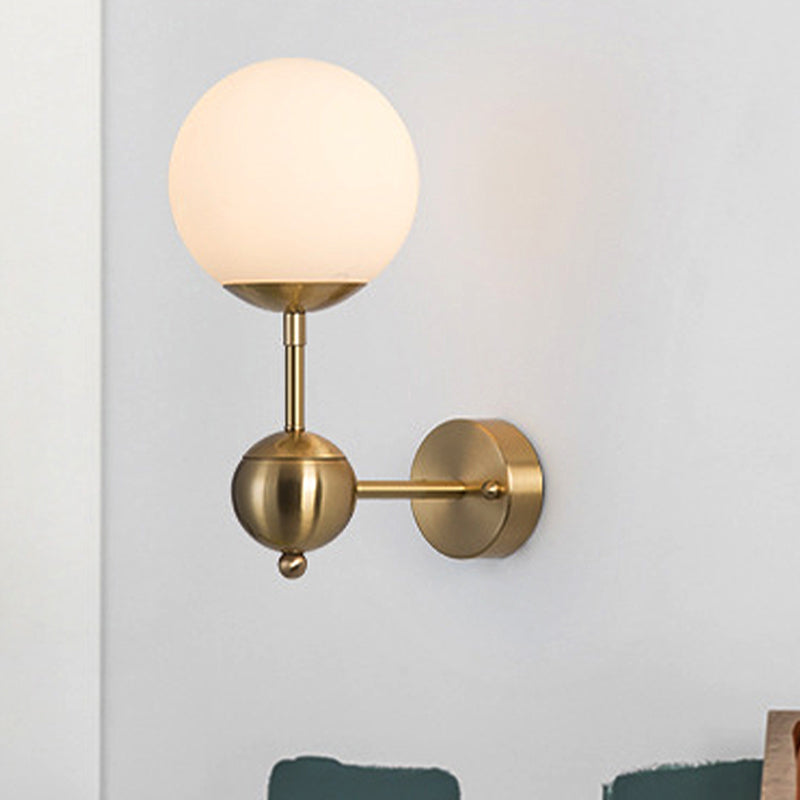 Modern Globe Wall Lighting Fixture 1 Bulb White Glass Sconce Light in Brass for Bathroom Clearhalo 'Cast Iron' 'Glass' 'Industrial' 'Modern wall lights' 'Modern' 'Tiffany' 'Traditional wall lights' 'Wall Lamps & Sconces' 'Wall Lights' Lighting' 250621