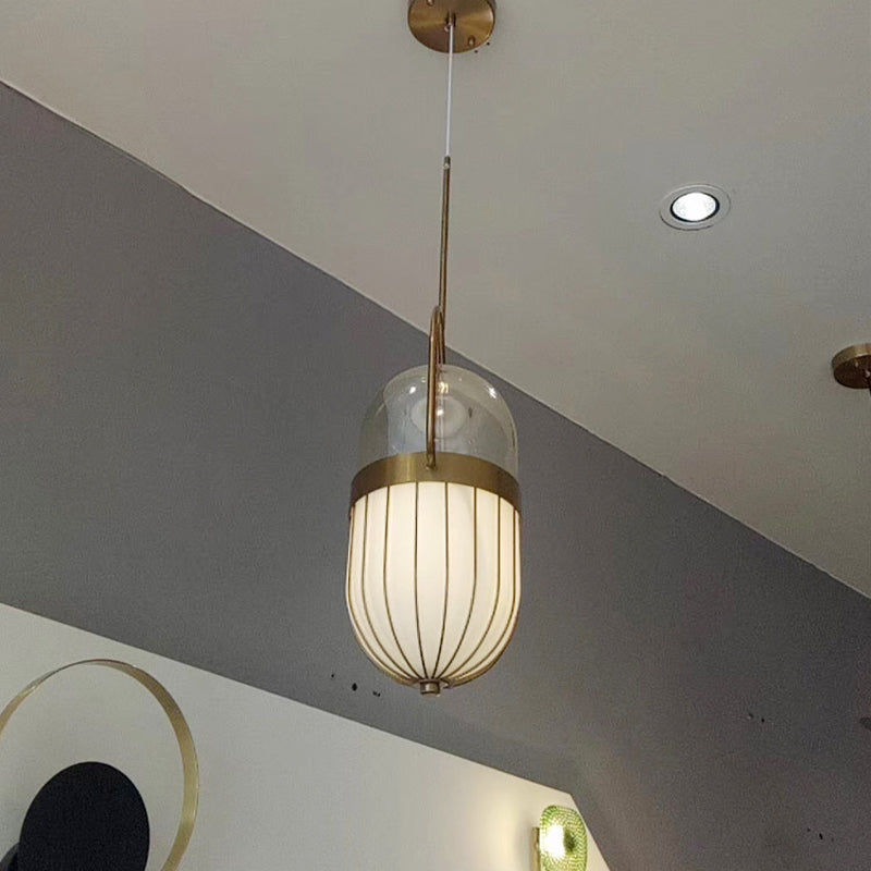 Postmodern Pill Capsule Pendant Lamp Clear and White Glass 1 Head Dining Room Hanging Ceiling Light in Gold Clearhalo 'Ceiling Lights' 'Glass shade' 'Glass' 'Modern Pendants' 'Modern' 'Pendant Lights' 'Pendants' Lighting' 257574