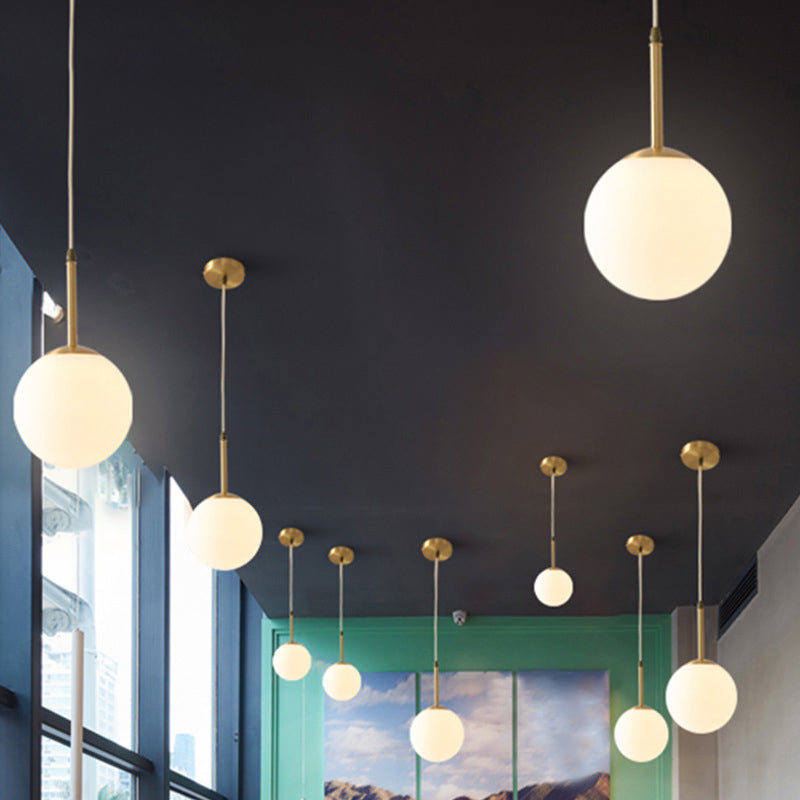 Brass 1-Light Pendant Light Mid-Century Modern Spherical White Glass Hanging Lamp Clearhalo 'Ceiling Lights' 'Glass shade' 'Glass' 'Modern Pendants' 'Modern' 'Pendant Lights' 'Pendants' Lighting' 2579340