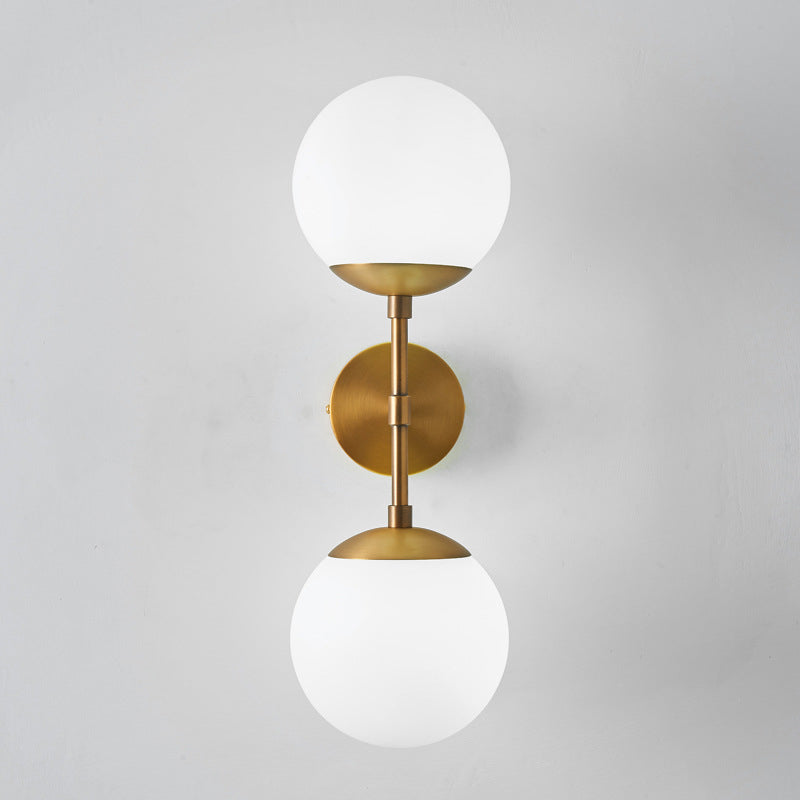 Armed Double Globe Wall Sconce Light Minimalist Milky Glass 2-Light Wall Mount Lamp in Brass Brass Clearhalo 'Cast Iron' 'Glass' 'Industrial' 'Modern wall lights' 'Modern' 'Tiffany' 'Traditional wall lights' 'Wall Lamps & Sconces' 'Wall Lights' Lighting' 269656