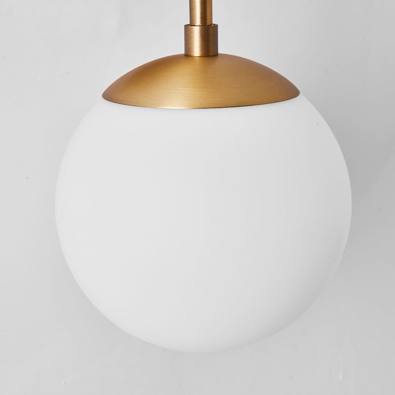 Armed Double Globe Wall Sconce Light Minimalist Milky Glass 2-Light Wall Mount Lamp in Brass Clearhalo 'Cast Iron' 'Glass' 'Industrial' 'Modern wall lights' 'Modern' 'Tiffany' 'Traditional wall lights' 'Wall Lamps & Sconces' 'Wall Lights' Lighting' 269661