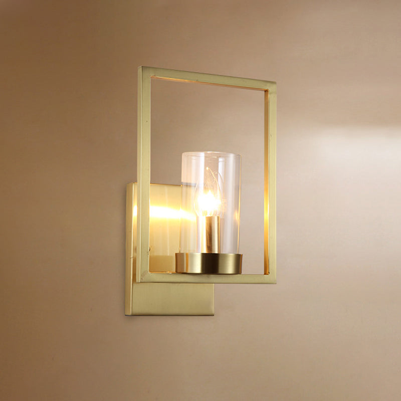 Cylindrical Bedroom Wall Sconce Clear Glass 1 Bulb Contemporary Wall Light Fixture in Brass with Frame Clearhalo 'Cast Iron' 'Glass' 'Industrial' 'Modern wall lights' 'Modern' 'Tiffany' 'Traditional wall lights' 'Wall Lamps & Sconces' 'Wall Lights' Lighting' 274585