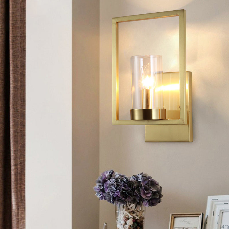 Cylindrical Bedroom Wall Sconce Clear Glass 1 Bulb Contemporary Wall Light Fixture in Brass with Frame Clearhalo 'Cast Iron' 'Glass' 'Industrial' 'Modern wall lights' 'Modern' 'Tiffany' 'Traditional wall lights' 'Wall Lamps & Sconces' 'Wall Lights' Lighting' 274587