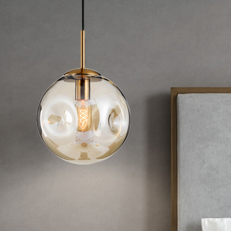 Globe Pendant Light Nordic Amber/Smoke Gray Dimpled Glass 1 Head Dining Room Hanging Ceiling Light Clearhalo 'Ceiling Lights' 'Modern Pendants' 'Modern' 'Pendant Lights' 'Pendants' Lighting' 289058