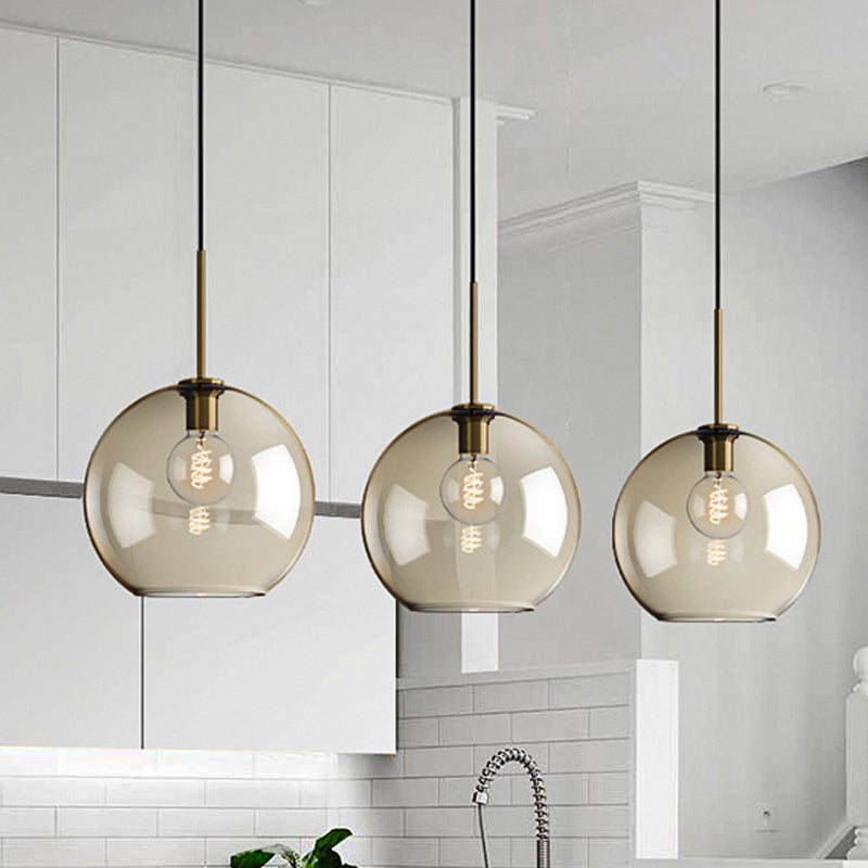 Amber Glass Sphere Pendant Lighting Modern 1 Head 8"/10"/12" Wide Brass Hanging Ceiling Light Clearhalo 'Ceiling Lights' 'Modern Pendants' 'Modern' 'Pendant Lights' 'Pendants' Lighting' 290042