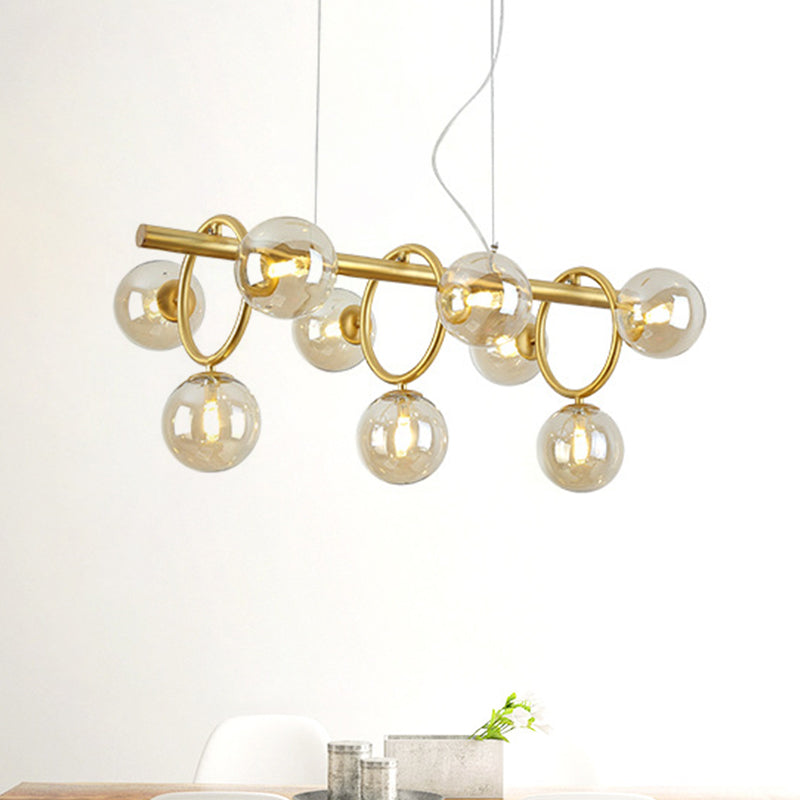 Gold Round Pendant Lighting Modern 9 Bulbs Cognac Glass LED Island Lamp with Linear Design Clearhalo 'Ceiling Lights' 'Chandeliers' 'Glass shade' 'Glass' 'Island Lights' Lighting' 303532