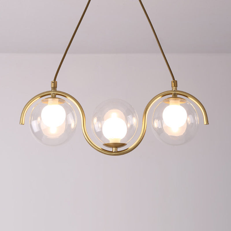 Minimalist Orb Shaped Clear Glass Island Lighting 3/5/7 Lights Hanging Light Fixture in Brass 3 Brass Clearhalo 'Ceiling Lights' 'Close To Ceiling Lights' 'Glass shade' 'Glass' 'Island Lights' Lighting' 311165