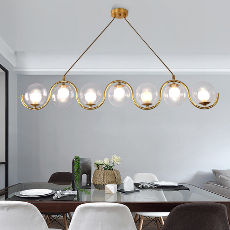 Minimalist Orb Shaped Clear Glass Island Lighting 3/5/7 Lights Hanging Light Fixture in Brass 7 Brass Clearhalo 'Ceiling Lights' 'Close To Ceiling Lights' 'Glass shade' 'Glass' 'Island Lights' Lighting' 311166