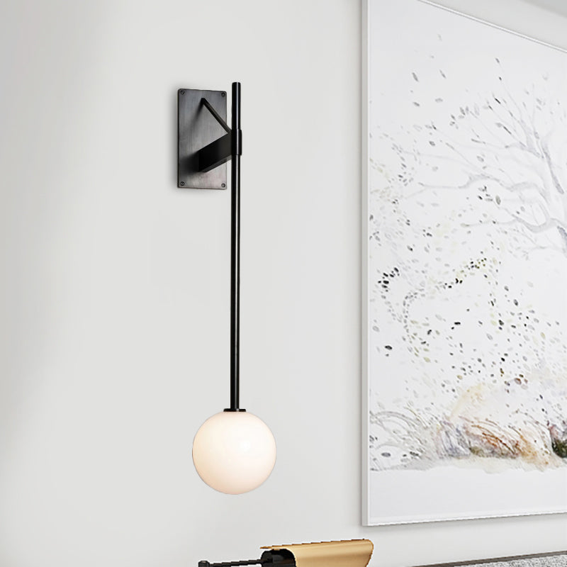 Round Sconce Modern Milk Glass 1 Bulb Black Wall Mount Light Fixture with Metal Pencil Arm Black Clearhalo 'Cast Iron' 'Glass' 'Industrial' 'Modern wall lights' 'Modern' 'Tiffany' 'Traditional wall lights' 'Wall Lamps & Sconces' 'Wall Lights' Lighting' 323669