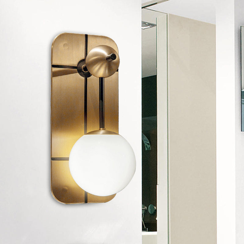 Opal Glass Ball Sconce Modernist 1 Head Brass Wall Mounted Light Fixture with Metal Rectangle Backplate Brass Clearhalo 'Cast Iron' 'Glass' 'Industrial' 'Modern wall lights' 'Modern' 'Tiffany' 'Traditional wall lights' 'Wall Lamps & Sconces' 'Wall Lights' Lighting' 324115