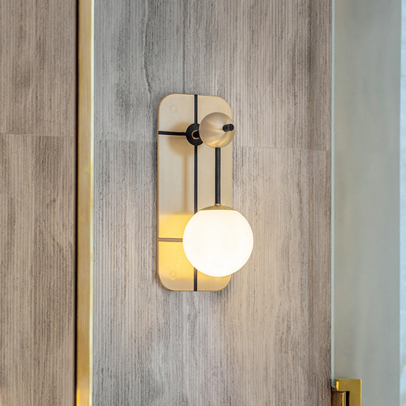 Opal Glass Ball Sconce Modernist 1 Head Brass Wall Mounted Light Fixture with Metal Rectangle Backplate Clearhalo 'Cast Iron' 'Glass' 'Industrial' 'Modern wall lights' 'Modern' 'Tiffany' 'Traditional wall lights' 'Wall Lamps & Sconces' 'Wall Lights' Lighting' 324117