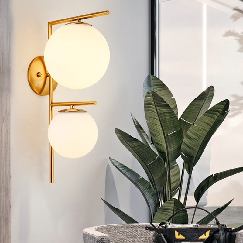 White Glass Spherical Sconce Contemporary 2 Heads Wall Mounted Light Fixture in Gold Gold Clearhalo 'Cast Iron' 'Glass' 'Industrial' 'Modern wall lights' 'Modern' 'Tiffany' 'Traditional wall lights' 'Wall Lamps & Sconces' 'Wall Lights' Lighting' 324180