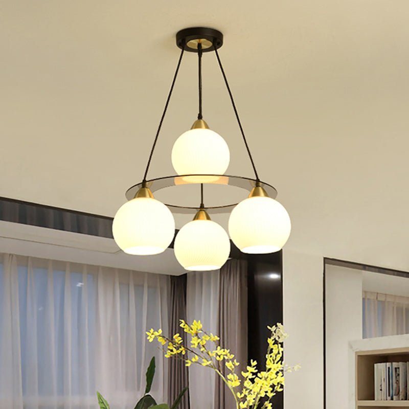 Modern 4 Heads Chandelier Light Black and Gold Spherical Ceiling Suspension Lamp with Opal Glass Shade Clearhalo 'Ceiling Lights' 'Chandeliers' 'Glass shade' 'Glass' 'Modern Chandeliers' 'Modern' Lighting' 324346