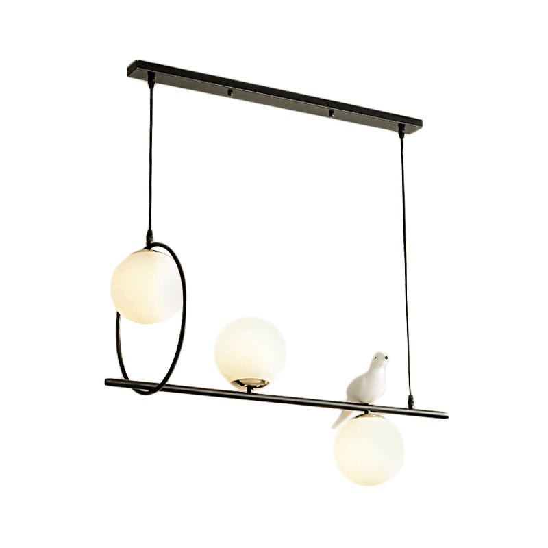 3 Heads Globe Island Lamp Modernist Milk Glass Pendant Lighting Fixture in Black with Bird Clearhalo 'Ceiling Lights' 'Chandeliers' 'Glass shade' 'Glass' 'Island Lights' Lighting' 324761