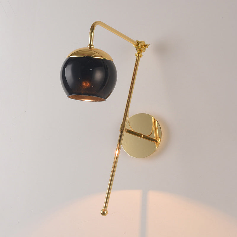 Ball Wall Lighting Modern Clear/Black Glass 1 Bulb Bedside Sconce Light Fixture with Metal Arm Clearhalo 'Cast Iron' 'Glass' 'Industrial' 'Modern wall lights' 'Modern' 'Tiffany' 'Traditional wall lights' 'Wall Lamps & Sconces' 'Wall Lights' Lighting' 326077