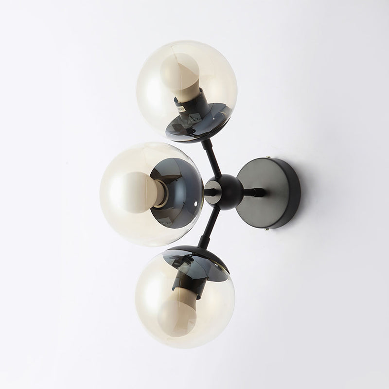 3 Bulbs Spherical Vanity Light Modern Clear Glass Wall Mounted Lighting in Black for Bathroom Clearhalo 'Cast Iron' 'Glass' 'Industrial' 'Modern wall lights' 'Modern' 'Tiffany' 'Traditional wall lights' 'Wall Lamps & Sconces' 'Wall Lights' Lighting' 330881