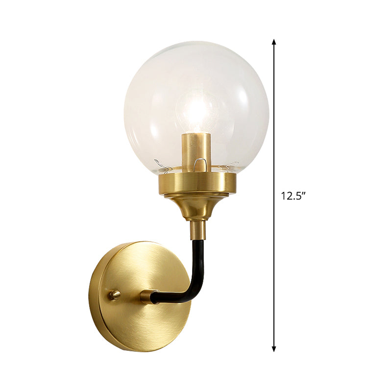 Simple Globe Wall Lighting Clear Glass 1 Bulb Sconce Light Fixture in Brass with Curved Arm Clearhalo 'Cast Iron' 'Glass' 'Industrial' 'Modern wall lights' 'Modern' 'Tiffany' 'Traditional wall lights' 'Wall Lamps & Sconces' 'Wall Lights' Lighting' 331360