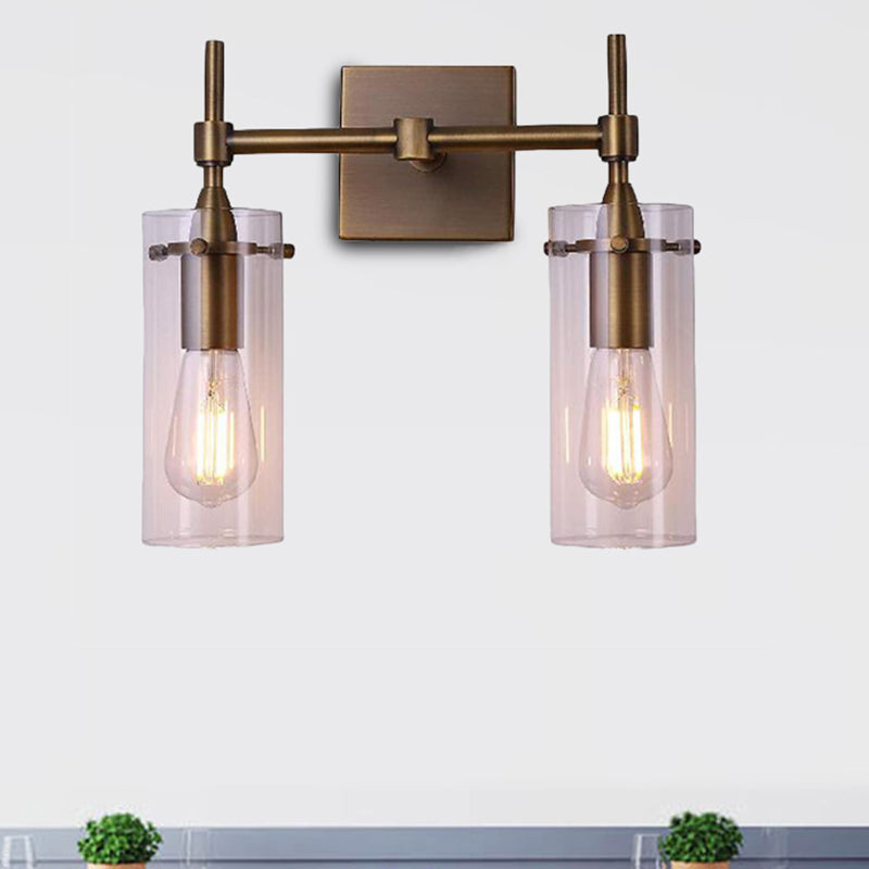 Clear Glass Cylinder Wall Sconce Modern 2 Lights Dining Room Lighting Fixture in Aged Brass Clearhalo 'Cast Iron' 'Glass' 'Industrial wall lights' 'Industrial' 'Middle century wall lights' 'Modern' 'Tiffany' 'Traditional wall lights' 'Wall Lamps & Sconces' 'Wall Lights' Lighting' 467674