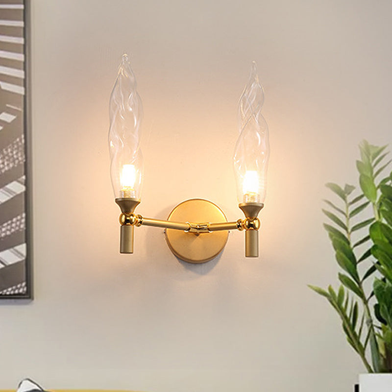 Double Arm Wall Lighting Modernism Metal 2 Bulbs Living Room Wall Mount Sconce in Gold with Torch Clear Glass Shade Clearhalo 'Cast Iron' 'Glass' 'Industrial' 'Modern wall lights' 'Modern' 'Tiffany' 'Traditional wall lights' 'Wall Lamps & Sconces' 'Wall Lights' Lighting' 512885