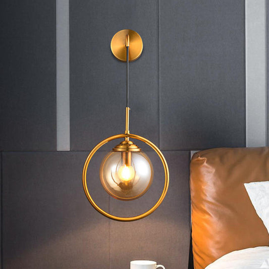 Metal Ring Sconce Lighting Modern 1-Bulb Brass Wall Mounted Lamp with Sphere Tan Glass Shade for Bedside Brass Clearhalo 'Cast Iron' 'Glass' 'Industrial' 'Modern wall lights' 'Modern' 'Tiffany' 'Traditional wall lights' 'Wall Lamps & Sconces' 'Wall Lights' Lighting' 513009