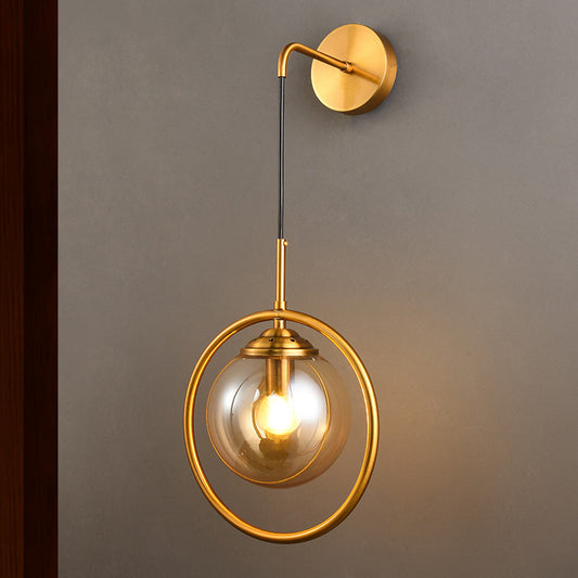 Metal Ring Sconce Lighting Modern 1-Bulb Brass Wall Mounted Lamp with Sphere Tan Glass Shade for Bedside Clearhalo 'Cast Iron' 'Glass' 'Industrial' 'Modern wall lights' 'Modern' 'Tiffany' 'Traditional wall lights' 'Wall Lamps & Sconces' 'Wall Lights' Lighting' 513011