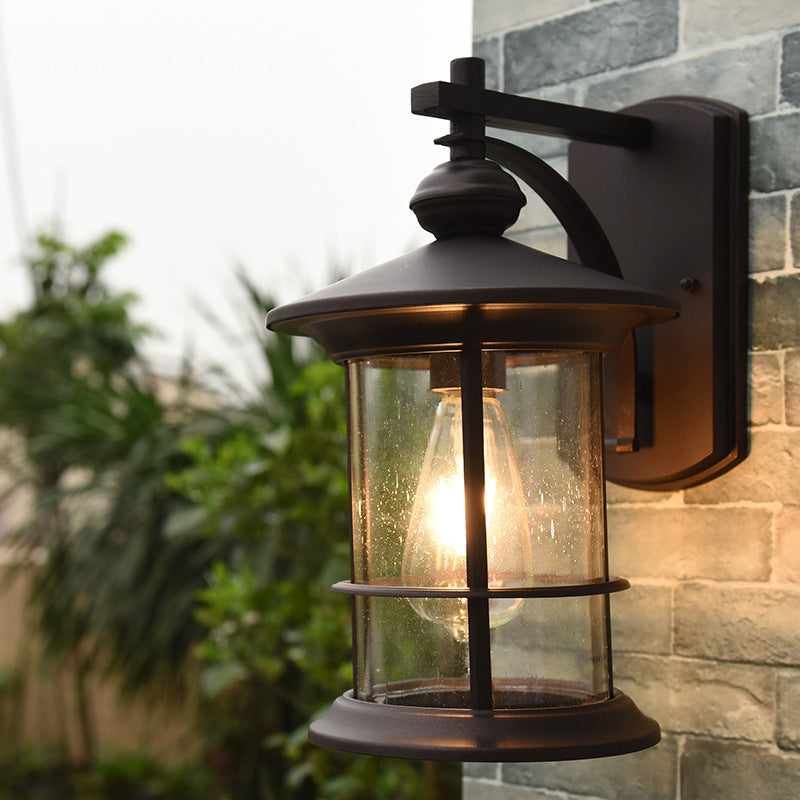 Clear Seeded Glass Cylinder Sconce Light Lodges 1-Bulb Outdoor Wall Mounted Lamp in Black/Coffee for Garden Black Clearhalo 'Wall Lamps & Sconces' 'Wall Lights' Lighting' 623795