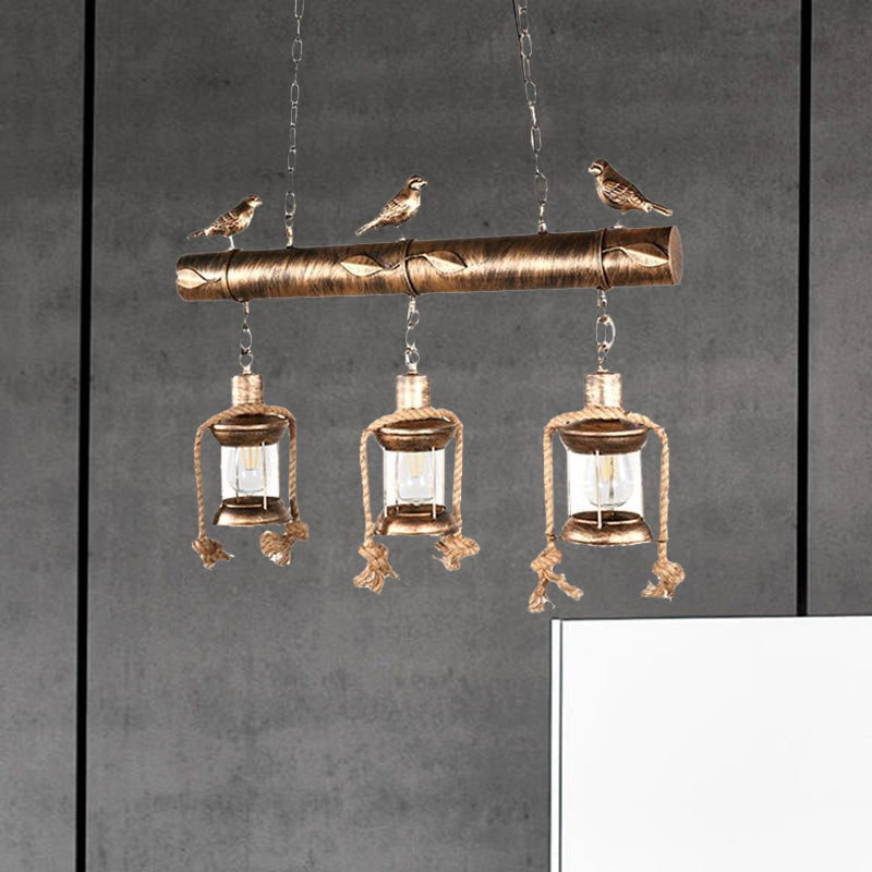 Coastal Lantern Island Pendant 3-Light Clear Glass Hanging Lamp Kit in Antique Brass with Bird Clearhalo 'Ceiling Lights' 'Island Lights' Lighting' 679353