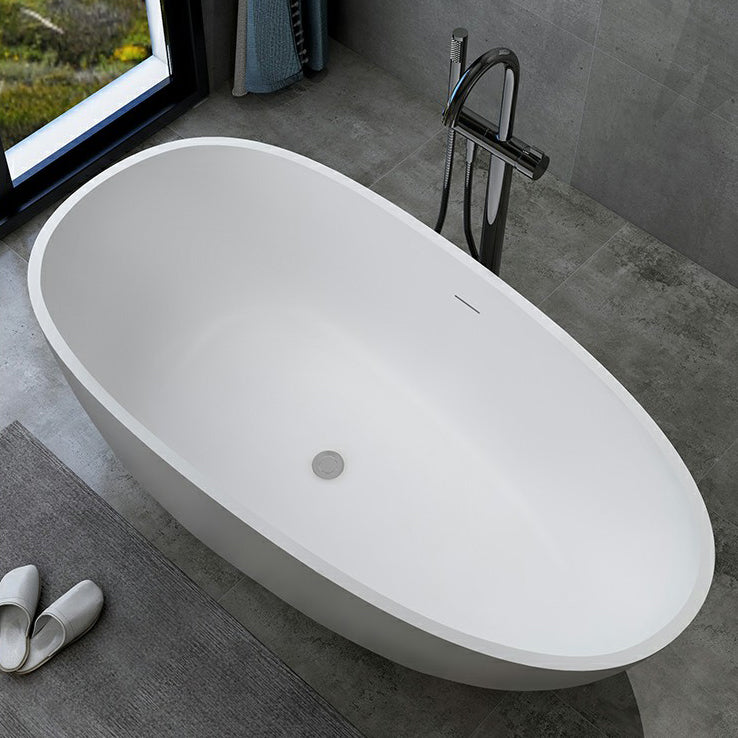 Modern Style Oval Freestanding Bathtub Stone Bathtub with Overflow Trim White 67"L x 31"W x 23"H 1\ (2.5cm) Clearhalo 'Bathroom Remodel & Bathroom Fixtures' 'Bathtubs' 'Home Improvement' 'home_improvement' 'home_improvement_bathtubs' 'Showers & Bathtubs' 6812036