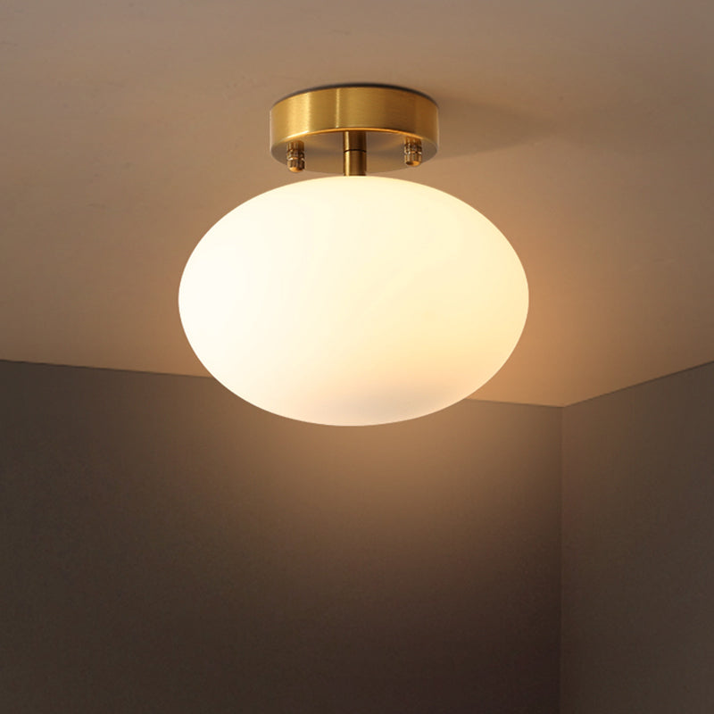 Gold Oval Semi Flush Light Fixture Minimalist 1-Light Cream Glass Close to Ceiling Lamp for Bedroom Gold Clearhalo 'Ceiling Lights' 'Close To Ceiling Lights' 'Close to ceiling' 'Glass shade' 'Glass' 'Pendant Lights' 'Semi-flushmount' Lighting' 730542