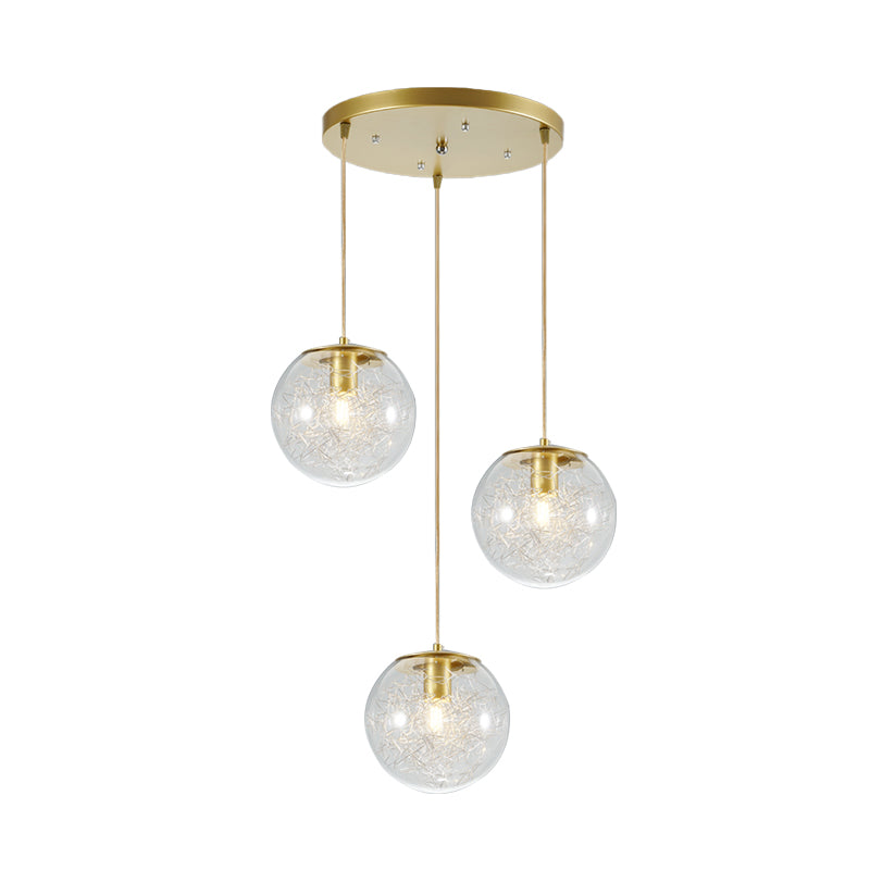 Minimalist Pumpkin Ball Multi Light Pendant Clear Glass 3 Lights Coffee House Hanging Lamp in Gold with Metal Line Deco Inside Clearhalo 'Ceiling Lights' 'Glass shade' 'Glass' 'Modern Pendants' 'Modern' 'Pendant Lights' 'Pendants' Lighting' 731483