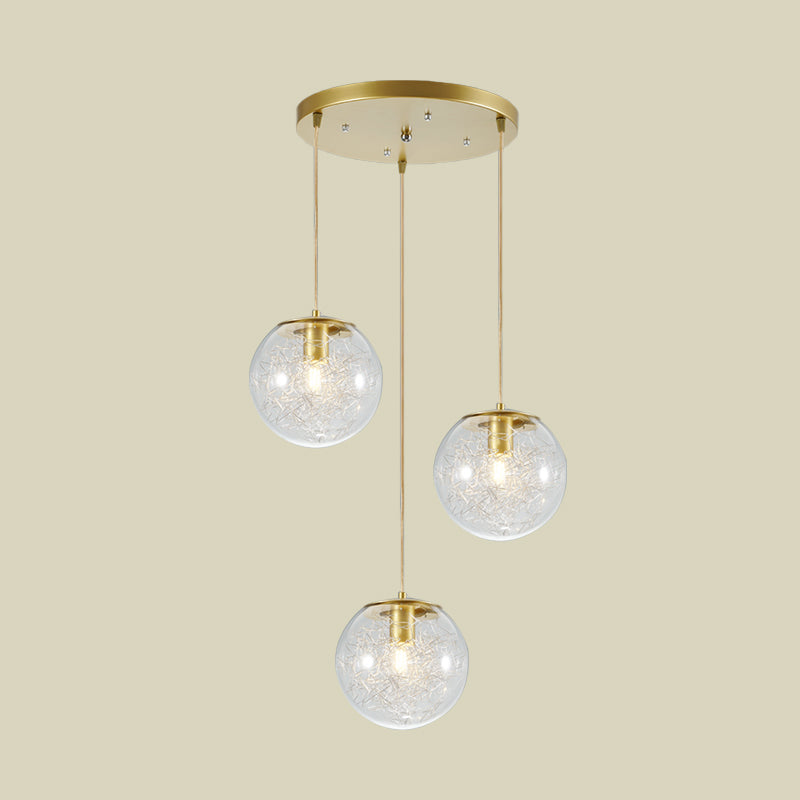 Minimalist Pumpkin Ball Multi Light Pendant Clear Glass 3 Lights Coffee House Hanging Lamp in Gold with Metal Line Deco Inside Clearhalo 'Ceiling Lights' 'Glass shade' 'Glass' 'Modern Pendants' 'Modern' 'Pendant Lights' 'Pendants' Lighting' 731484