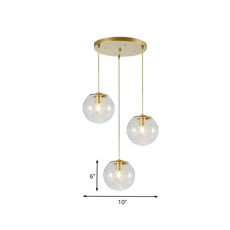 Minimalist Pumpkin Ball Multi Light Pendant Clear Glass 3 Lights Coffee House Hanging Lamp in Gold with Metal Line Deco Inside Clearhalo 'Ceiling Lights' 'Glass shade' 'Glass' 'Modern Pendants' 'Modern' 'Pendant Lights' 'Pendants' Lighting' 731485