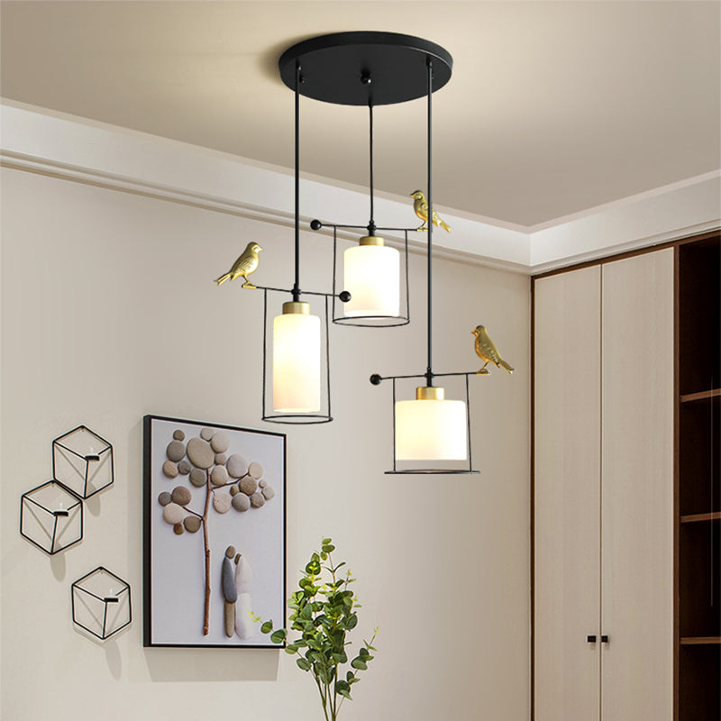 Cylinder Dining Room Cluster Pendant Cream/Smoke Gray Glass 3 Bulbs Modernism Suspension Lamp with Gold Bird Deco Cream Clearhalo 'Ceiling Lights' 'Chandeliers' 'Glass shade' 'Glass' 'Modern Pendants' 'Modern' 'Pendant Lights' 'Pendants' Lighting' 731491