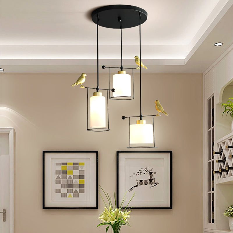 Cylinder Dining Room Cluster Pendant Cream/Smoke Gray Glass 3 Bulbs Modernism Suspension Lamp with Gold Bird Deco Clearhalo 'Ceiling Lights' 'Chandeliers' 'Glass shade' 'Glass' 'Modern Pendants' 'Modern' 'Pendant Lights' 'Pendants' Lighting' 731492