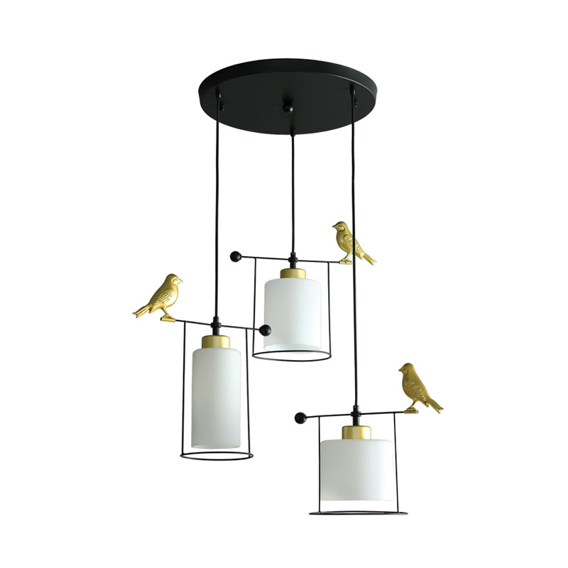 Cylinder Dining Room Cluster Pendant Cream/Smoke Gray Glass 3 Bulbs Modernism Suspension Lamp with Gold Bird Deco Clearhalo 'Ceiling Lights' 'Chandeliers' 'Glass shade' 'Glass' 'Modern Pendants' 'Modern' 'Pendant Lights' 'Pendants' Lighting' 731493