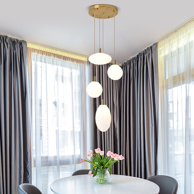 Gold/Black Ball and Oval Cluster Pendant Minimalism 4 Lights Cream Glass Hanging Lamp with Round Canopy Clearhalo 'Ceiling Lights' 'Close To Ceiling Lights' 'Glass shade' 'Glass' 'Modern Pendants' 'Modern' 'Pendant Lights' 'Pendants' Lighting' 735546