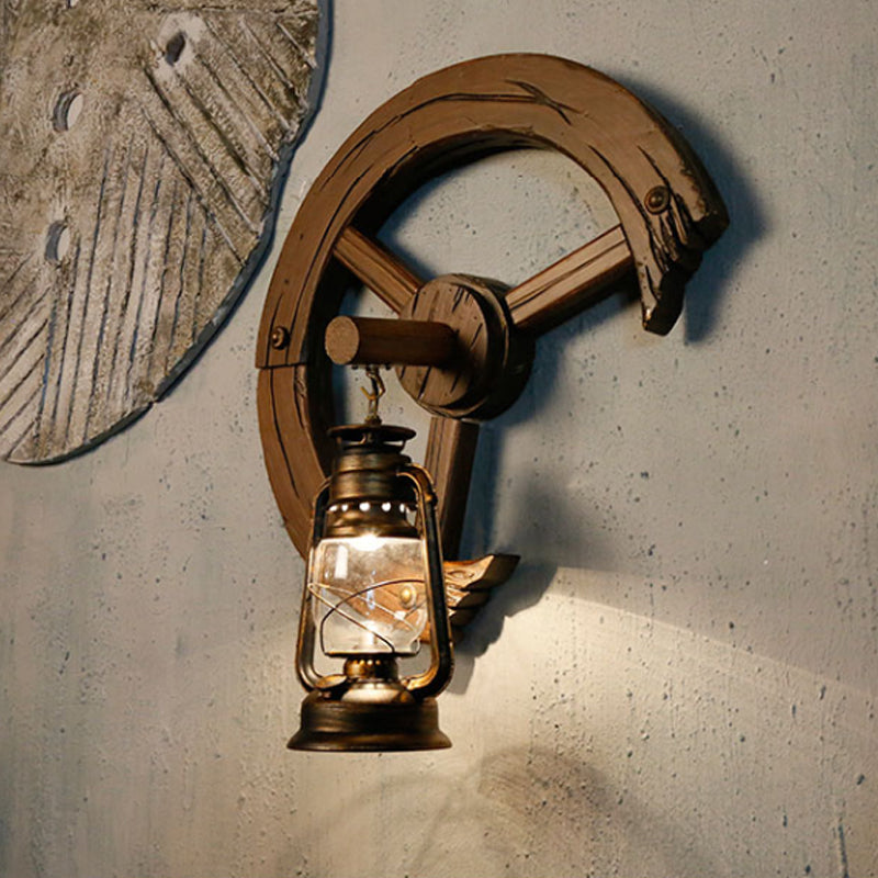 Clear Glass Kerosene Sconce Coastal 1 Light Bedroom Wall Mount Light Fixture in Brass with Wood Backplate Clearhalo 'Art deco wall lights' 'Cast Iron' 'Glass' 'Industrial wall lights' 'Industrial' 'Middle century wall lights' 'Modern' 'Rustic wall lights' 'Tiffany' 'Traditional wall lights' 'Wall Lamps & Sconces' 'Wall Lights' Lighting' 736376