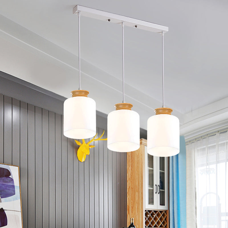 Cylinder Multi Light Chandelier Modern White Glass 3 Heads Wood Suspension Lamp with Round/Linear Canopy White Linear Clearhalo 'Ceiling Lights' 'Glass shade' 'Glass' 'Modern Pendants' 'Modern' 'Pendant Lights' 'Pendants' Lighting' 737159