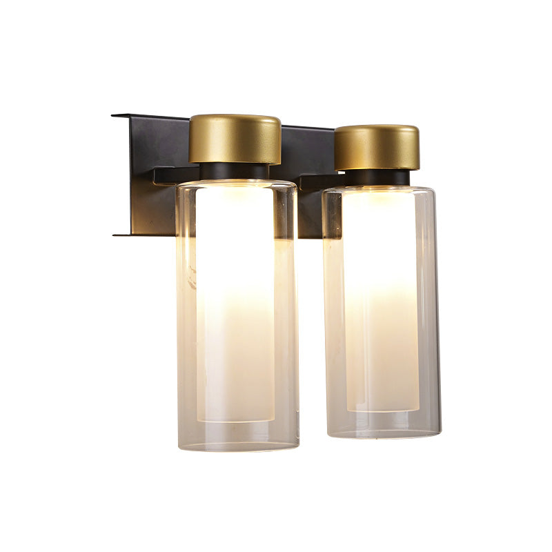 Brass Dual Cylinder Sconce Light Fixture Post-Modern 2 Bulbs Clear Glass LED Wall Mount Lamp Clearhalo 'Cast Iron' 'Glass' 'Industrial' 'Modern wall lights' 'Modern' 'Tiffany' 'Traditional wall lights' 'Wall Lamps & Sconces' 'Wall Lights' Lighting' 758912