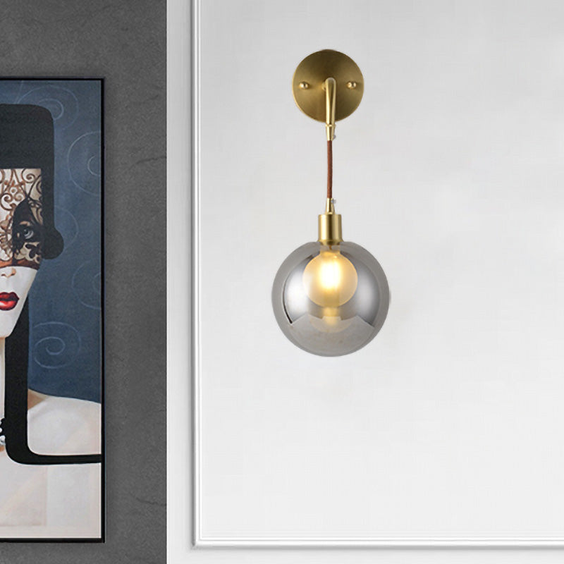 1 Light Corner Wall Light Fixture Postmodern Brass Finish Wall Mount Lamp with Orb Smoke Gray Glass Shade Brass Clearhalo 'Cast Iron' 'Glass' 'Industrial' 'Modern wall lights' 'Modern' 'Tiffany' 'Traditional wall lights' 'Wall Lamps & Sconces' 'Wall Lights' Lighting' 758937