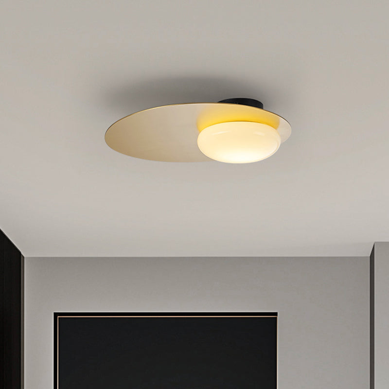 Cream Glass Ovoid Flush Mount Lamp Designer 1 Light Ceiling Lighting with Black/Brass Disk Top Brass Clearhalo 'Ceiling Lights' 'Close To Ceiling Lights' 'Close to ceiling' 'Flush mount' Lighting' 759900