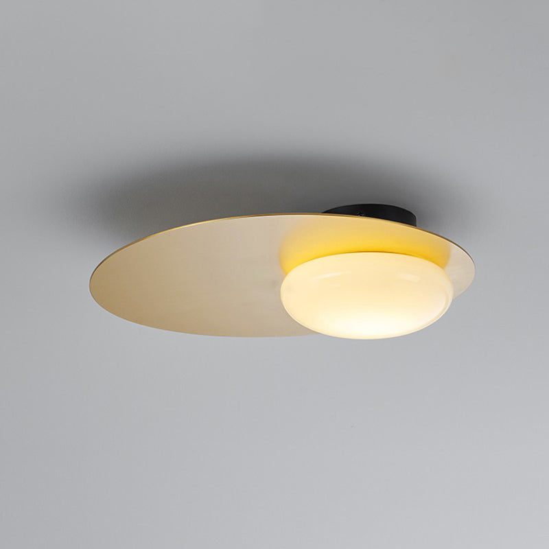 Cream Glass Ovoid Flush Mount Lamp Designer 1 Light Ceiling Lighting with Black/Brass Disk Top Clearhalo 'Ceiling Lights' 'Close To Ceiling Lights' 'Close to ceiling' 'Flush mount' Lighting' 759902