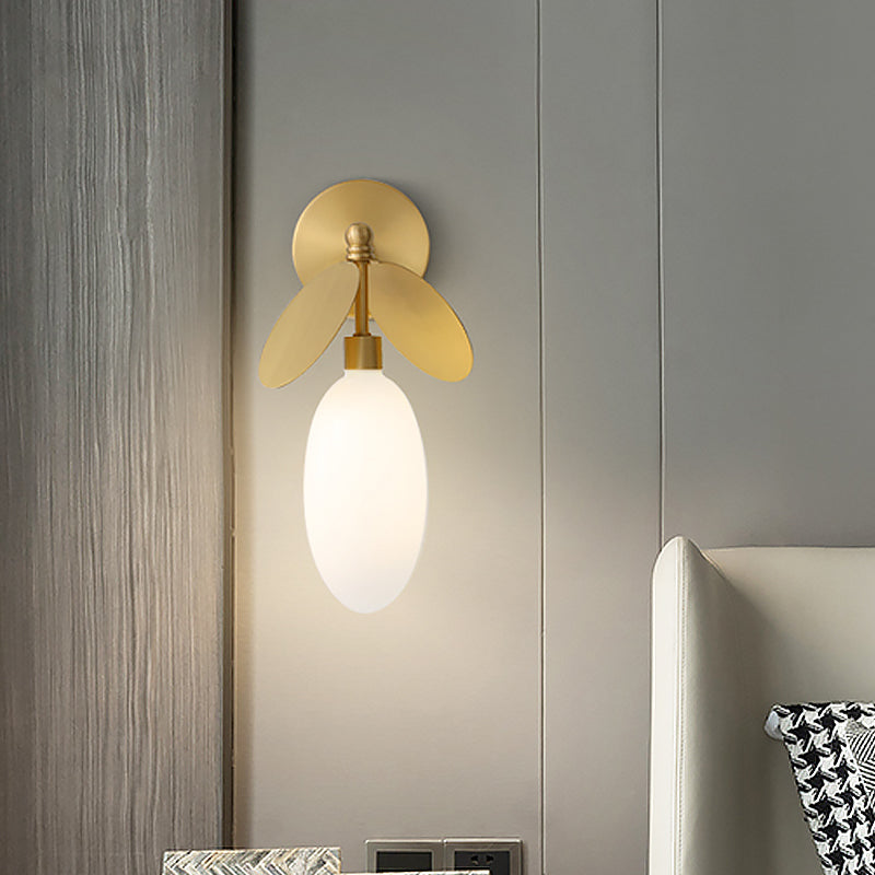Post Modern Globe/Oval Wall Mount Lamp Cream Glass 1 Light Bedside Wall Light in Brass with Leaf Deco Clearhalo 'Cast Iron' 'Glass' 'Industrial' 'Modern wall lights' 'Modern' 'Tiffany' 'Traditional wall lights' 'Wall Lamps & Sconces' 'Wall Lights' Lighting' 875288
