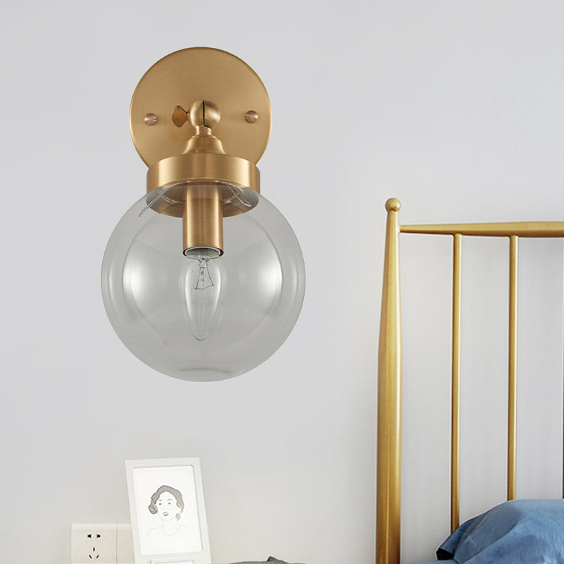 Modernist Ball Wall Mounted Lighting Clear Glass 1 Bulb Bedroom Rotatable Wall Lamp in Brass Brass Clearhalo 'Cast Iron' 'Glass' 'Industrial' 'Modern wall lights' 'Modern' 'Tiffany' 'Traditional wall lights' 'Wall Lamps & Sconces' 'Wall Lights' Lighting' 875308