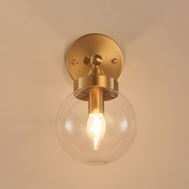 Modernist Ball Wall Mounted Lighting Clear Glass 1 Bulb Bedroom Rotatable Wall Lamp in Brass Clearhalo 'Cast Iron' 'Glass' 'Industrial' 'Modern wall lights' 'Modern' 'Tiffany' 'Traditional wall lights' 'Wall Lamps & Sconces' 'Wall Lights' Lighting' 875310