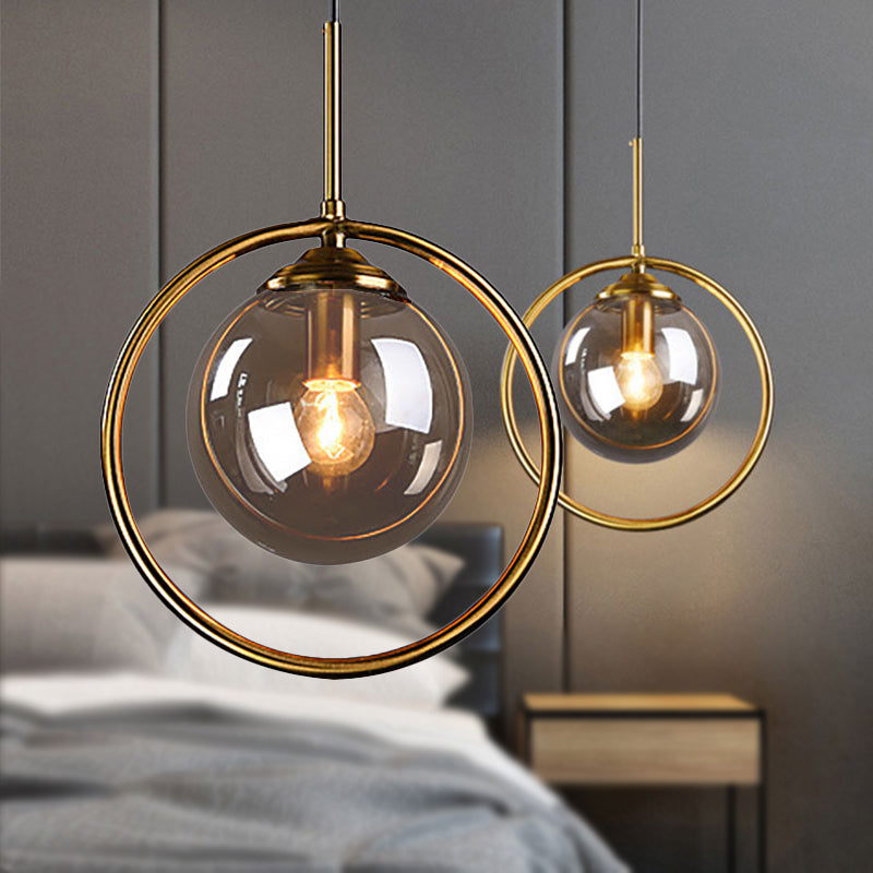 Amber/Smoke/Clear Glass Ball Pendant Lighting Post-Modernist 1 Light Ceiling Hung Fixture with Ring Frame Smoke Gray Clearhalo 'Ceiling Lights' 'Glass shade' 'Glass' 'Modern Pendants' 'Modern' 'Pendant Lights' 'Pendants' Lighting' 961885